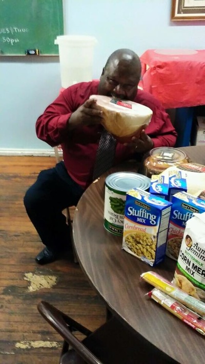Delivering a holiday meal with stuffing, canned goods, and fixings to a community partner
