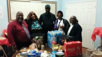 Chapter members gathered around donations of food, water, and holiday meals