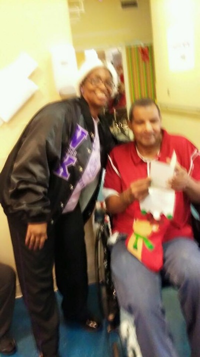 A Beta Chi member sharing holiday gifts with a nursing home resident